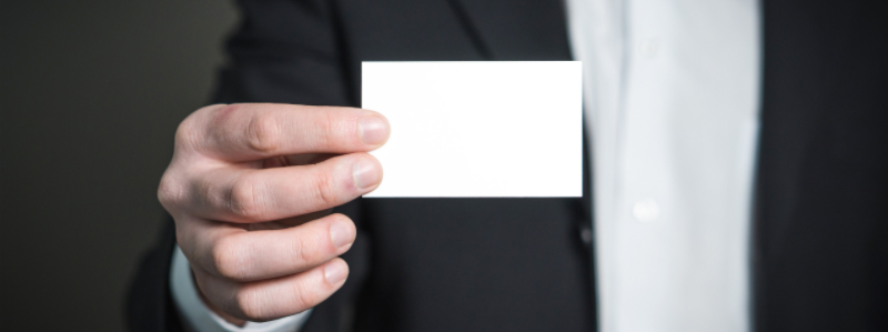 Man holding up business card