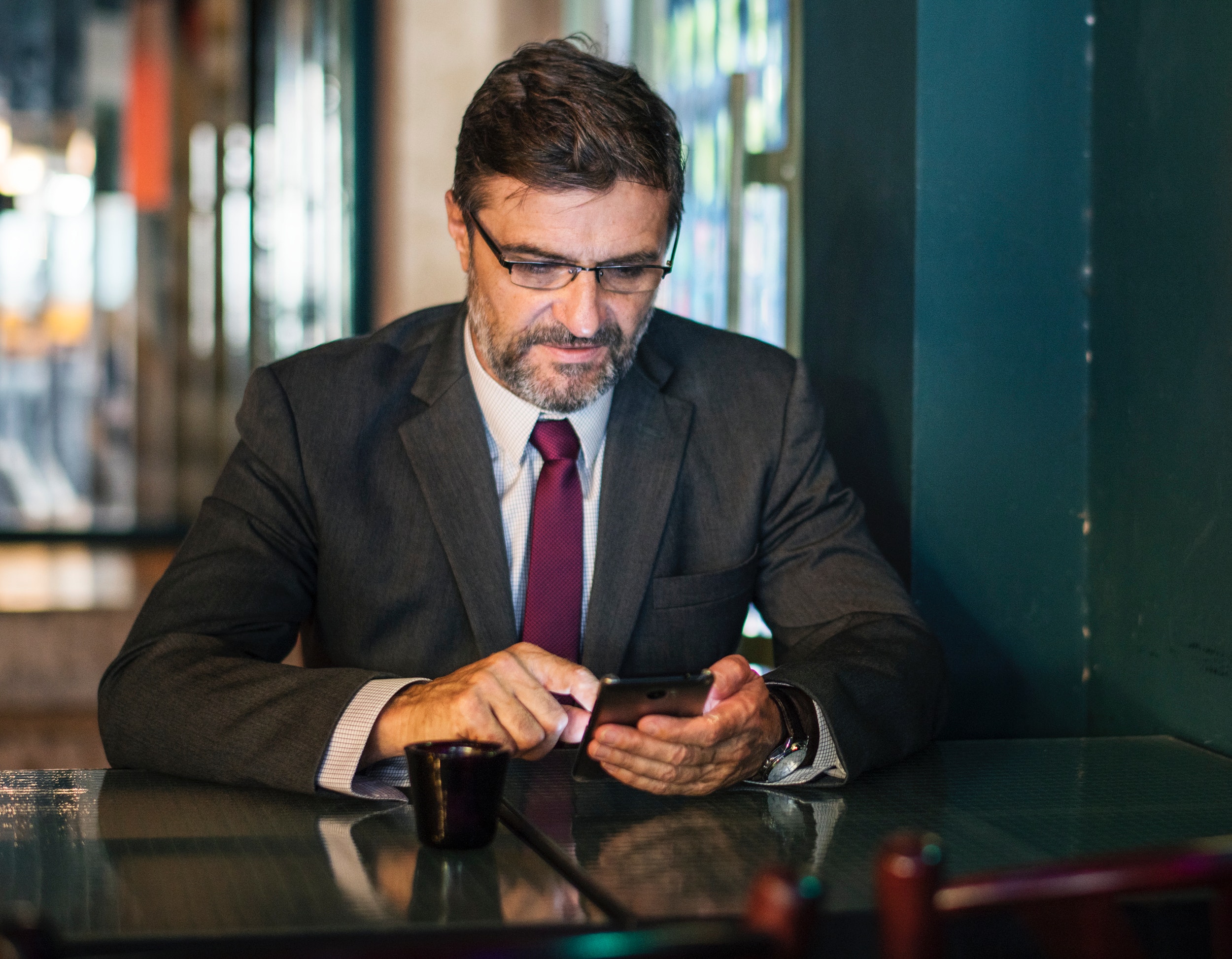 business man on his smartphone at a restaurant