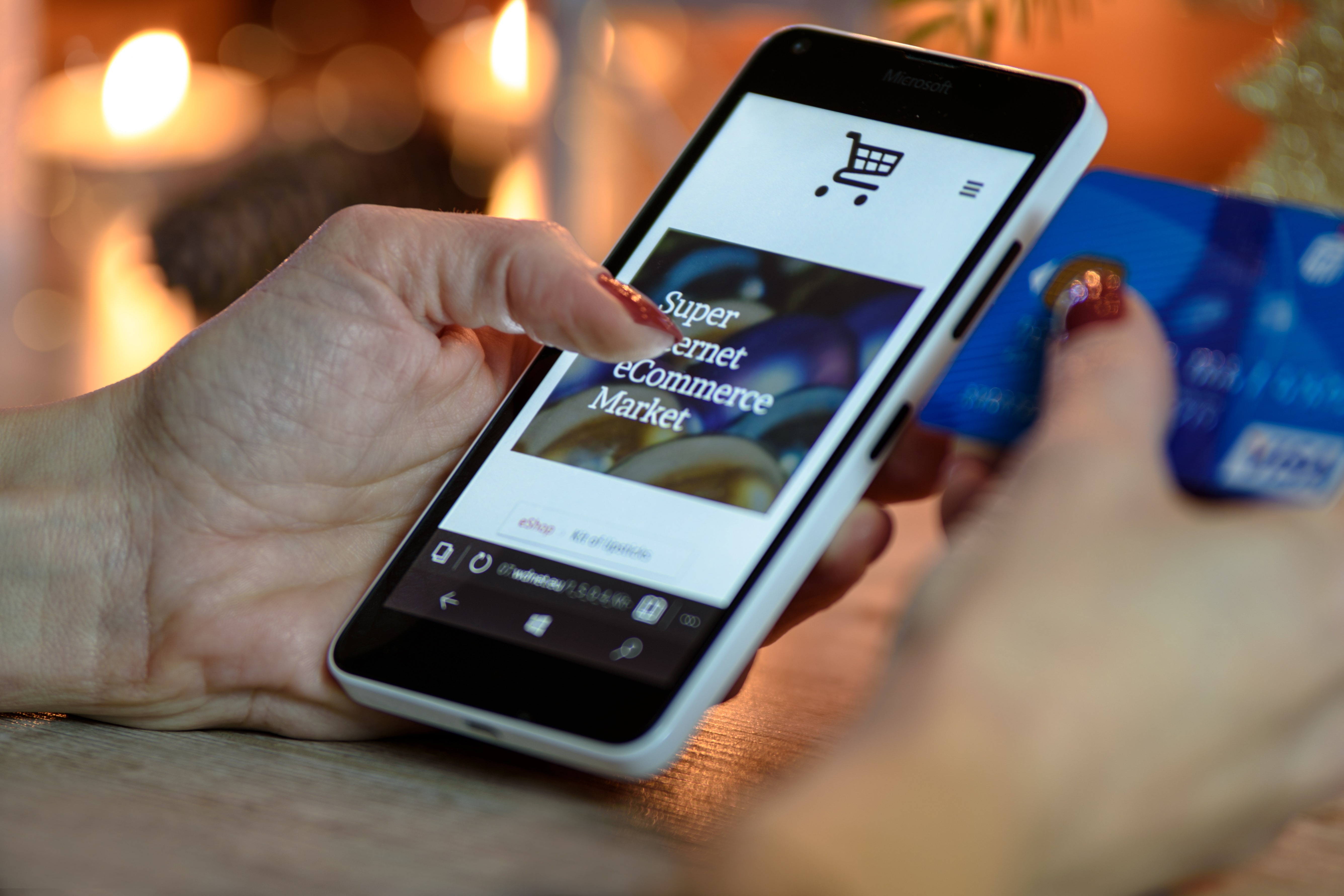 woman shopping on her phone typing in her credit card number