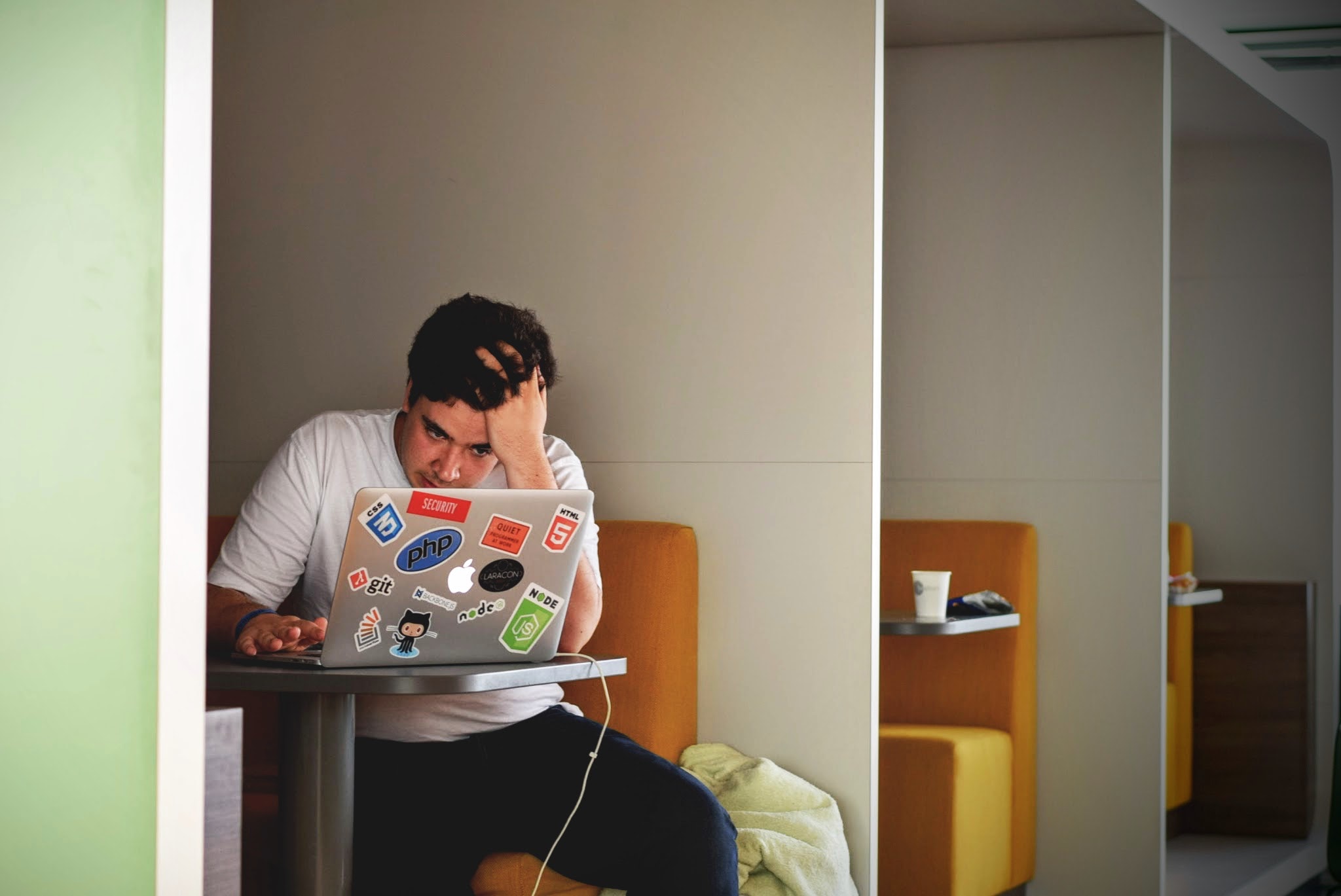 Man working on his laptop looking stressed
